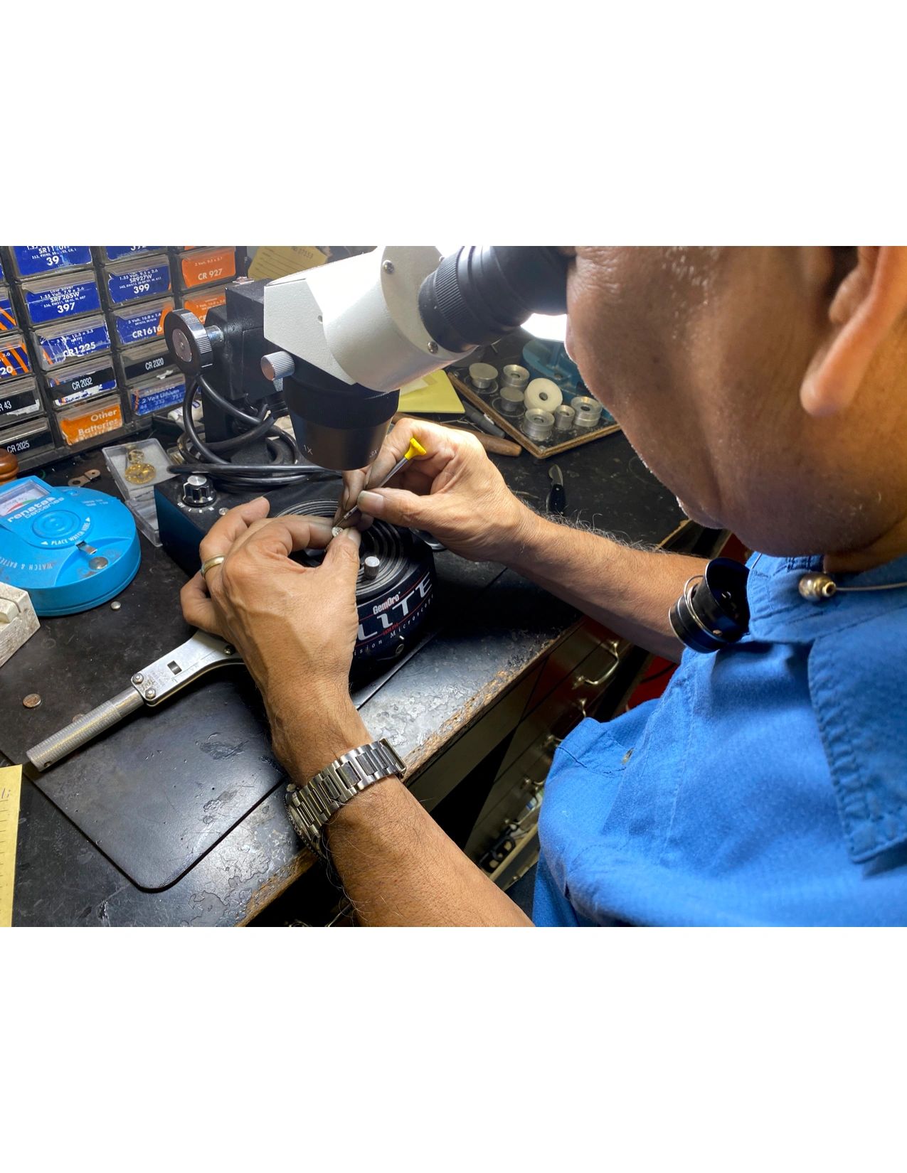 Jewelry and watch repair technician at workbench